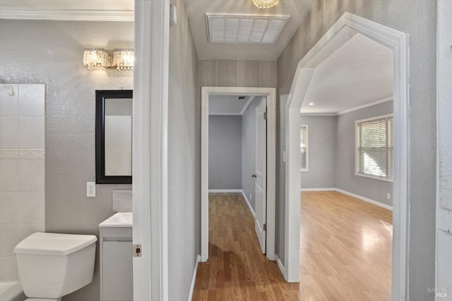 bathroom featuring hardwood / wood-style flooring, toilet, vanity, and crown molding