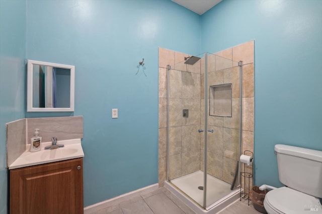 bathroom featuring tile patterned floors, a shower with door, toilet, and vanity