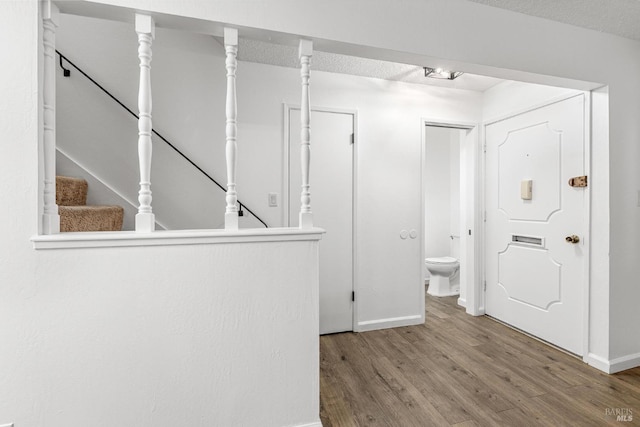 foyer with hardwood / wood-style flooring and a textured ceiling