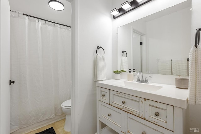 bathroom featuring toilet and vanity