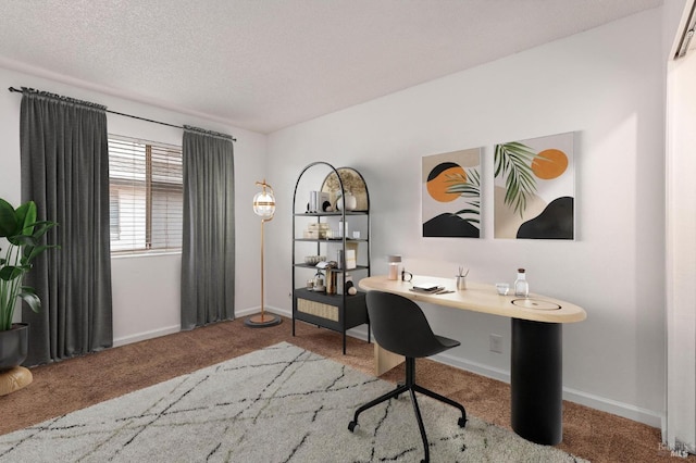 home office featuring a textured ceiling and carpet floors