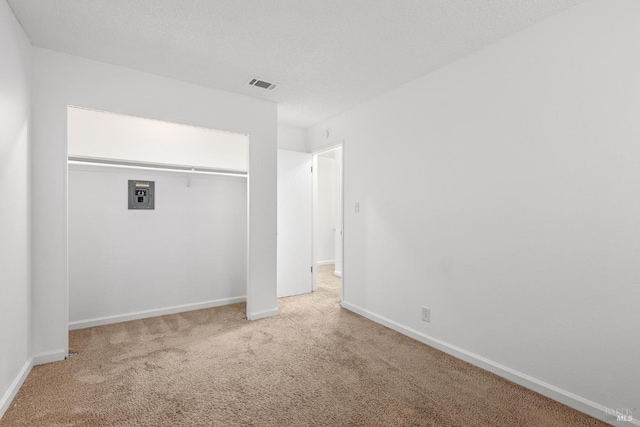 unfurnished bedroom with a closet and carpet flooring