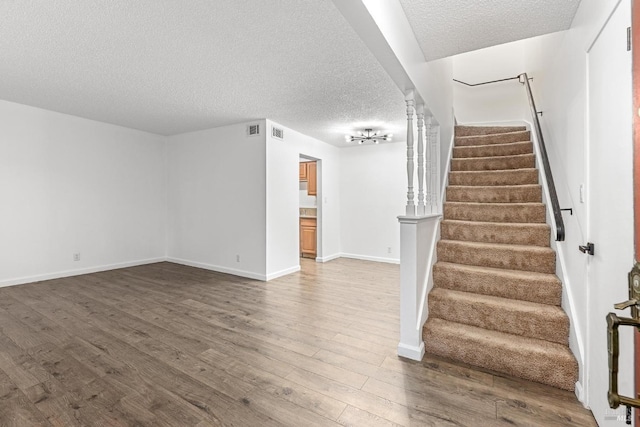 interior space with hardwood / wood-style floors and a textured ceiling