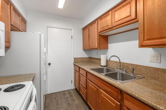 kitchen with sink, dark hardwood / wood-style floors, and white range with electric cooktop