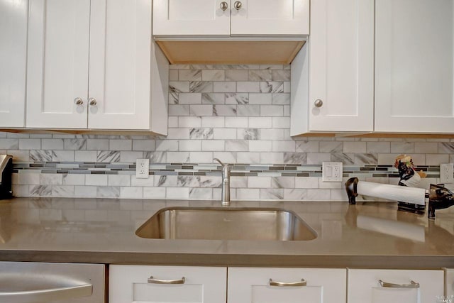 kitchen with sink, white cabinets, and tasteful backsplash