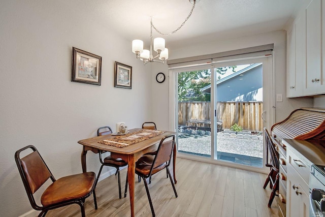 dining area with a chandelier and light hardwood / wood-style flooring