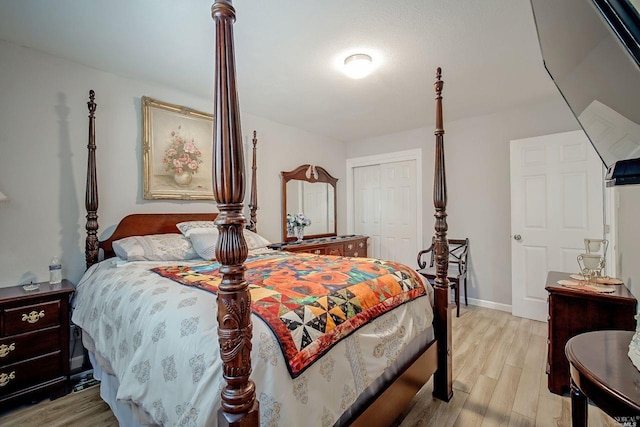 bedroom featuring light wood-type flooring and a closet