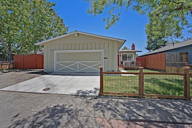 ranch-style home with a garage and a front lawn