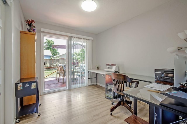 home office with light hardwood / wood-style flooring