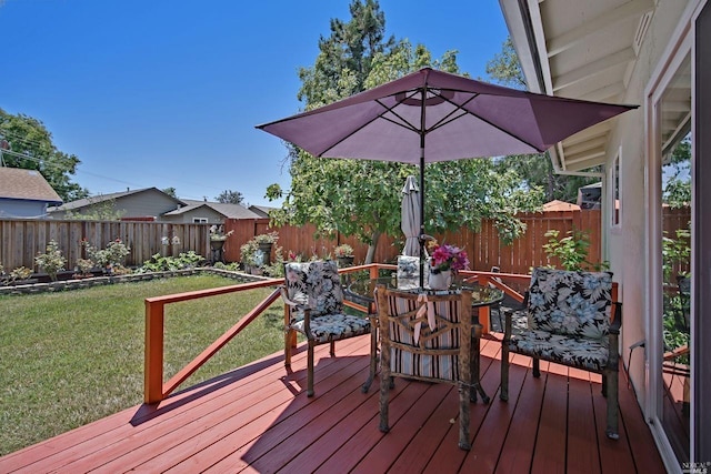 wooden deck featuring a yard