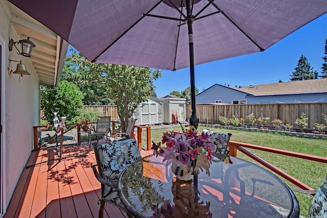 wooden terrace with a yard and a storage shed