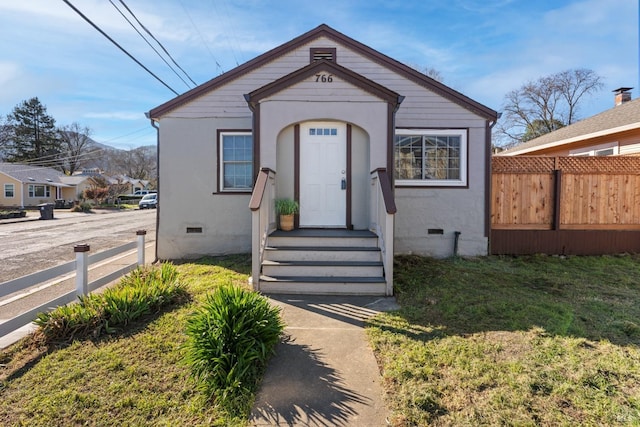 bungalow-style home featuring a front yard