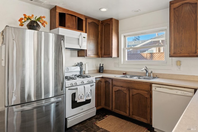 kitchen featuring sink and white appliances