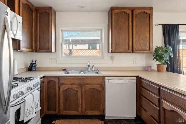 kitchen featuring sink and white appliances