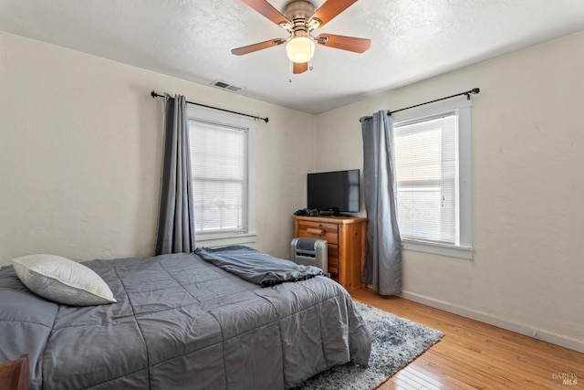 bedroom featuring light wood-type flooring and ceiling fan