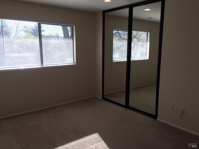 unfurnished bedroom featuring carpet floors and a closet