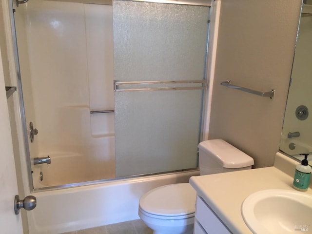 full bathroom featuring vanity, toilet, and combined bath / shower with glass door