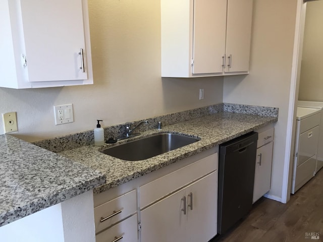 kitchen featuring washer / clothes dryer, black dishwasher, sink, white cabinets, and light stone counters