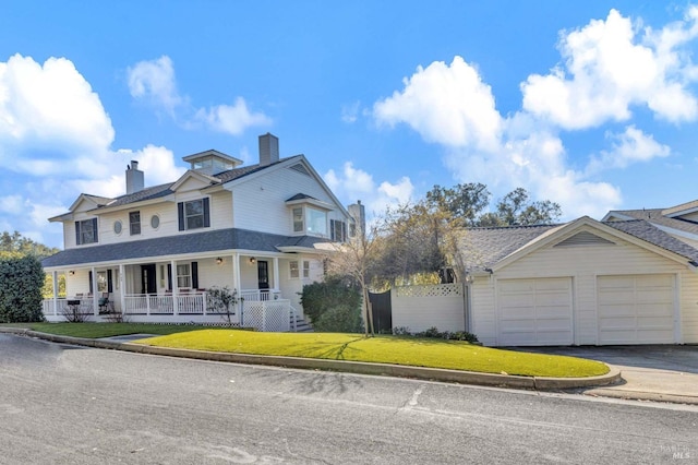 view of front of house featuring a garage, a front lawn, and a porch