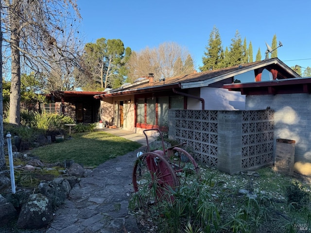 rear view of property featuring a yard