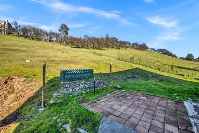 wooden deck with a lawn and a rural view