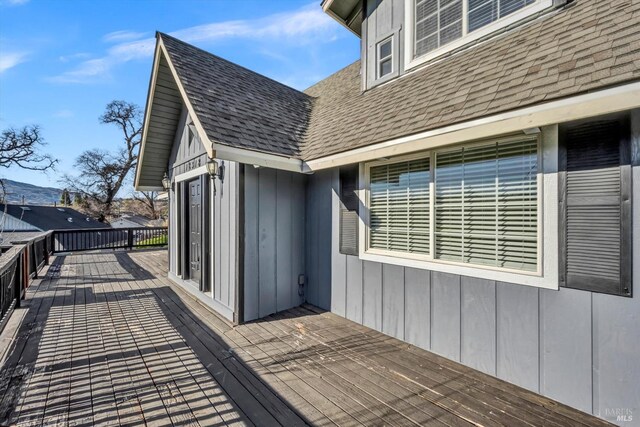 view of home's exterior with a garage and a deck