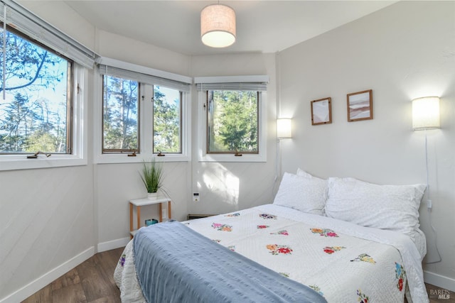 bedroom with wood finished floors and baseboards