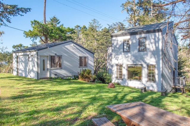 rear view of house featuring a yard