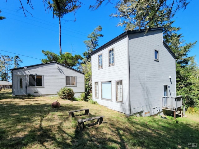 rear view of house with a yard