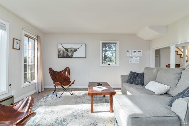 living room with a healthy amount of sunlight and light hardwood / wood-style flooring