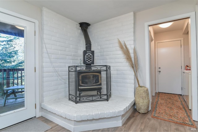 details featuring hardwood / wood-style flooring and a wood stove