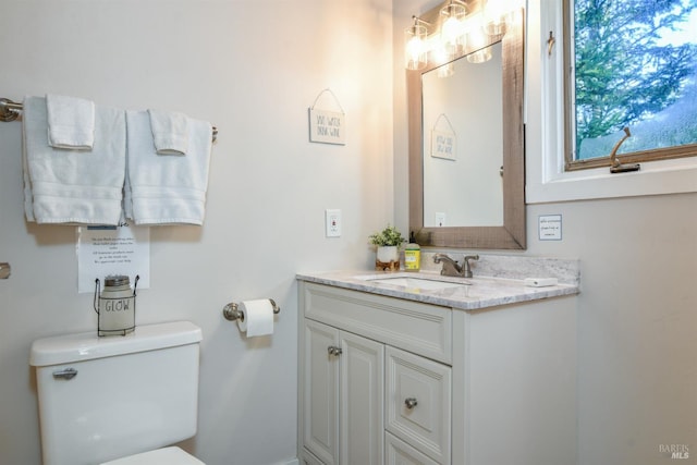 half bathroom featuring toilet and vanity