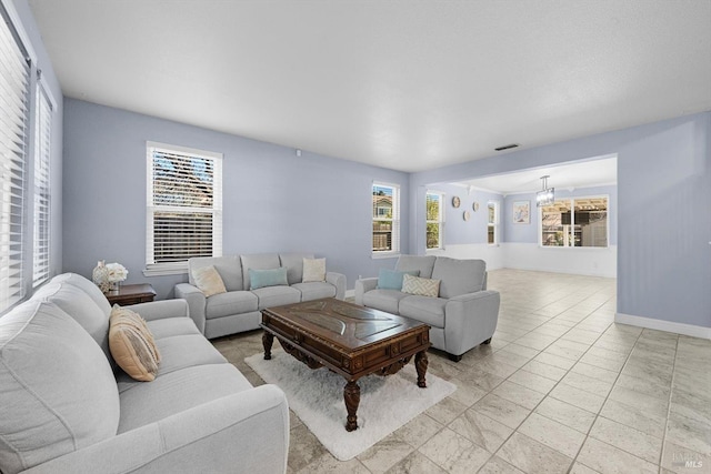 living room with a notable chandelier and plenty of natural light