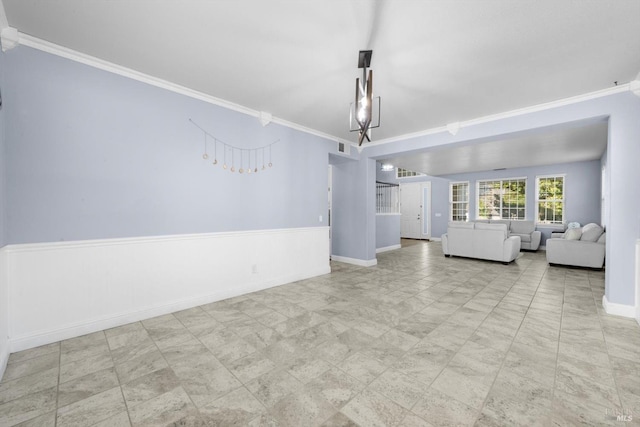 unfurnished living room with ornamental molding