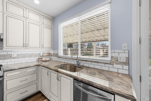 kitchen featuring sink, dishwasher, white cabinetry, and plenty of natural light