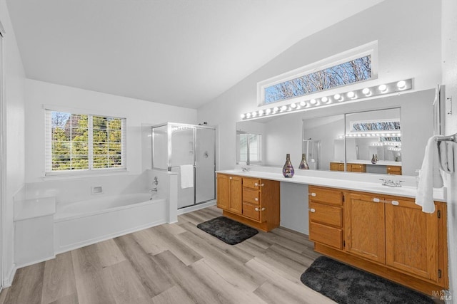 bathroom with vanity, wood-type flooring, plus walk in shower, and lofted ceiling