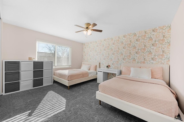 bedroom with ceiling fan and dark carpet