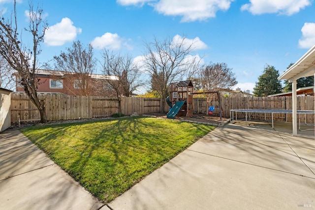 view of yard featuring a playground, a patio area, and a trampoline