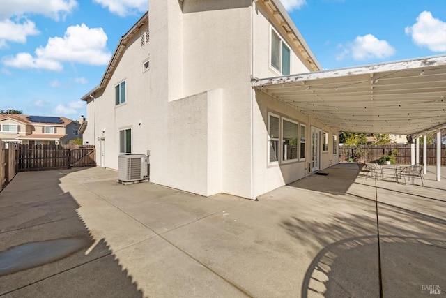 rear view of house featuring a patio area and central AC