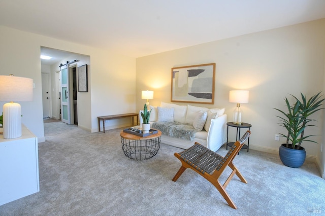 carpeted living room featuring a barn door