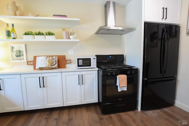 kitchen with white cabinets, wall chimney range hood, dark hardwood / wood-style flooring, and black appliances