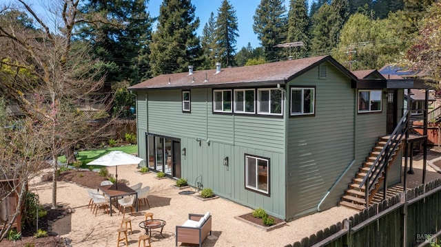 back of house featuring an outdoor fire pit and a patio