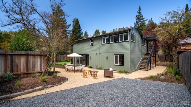 rear view of property with an outdoor fire pit and a patio area