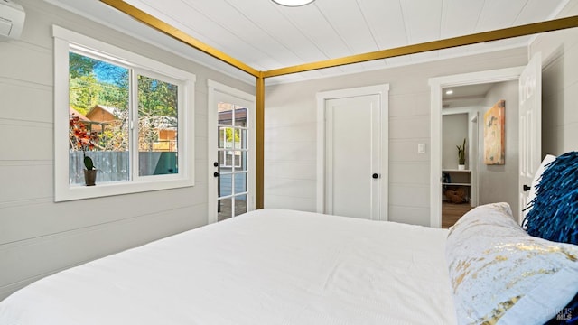 bedroom featuring wooden ceiling and a wall unit AC