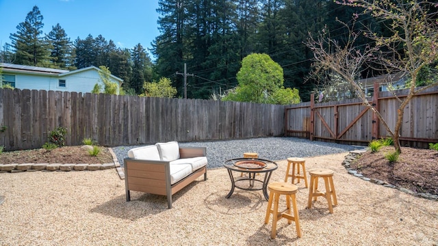 view of patio featuring an outdoor living space with a fire pit