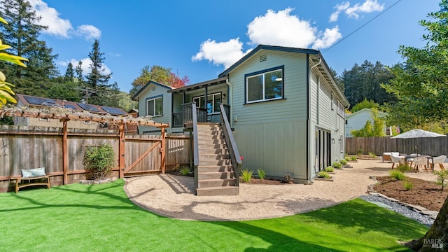 rear view of property with a patio area and a lawn