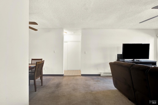 office space with ceiling fan, carpet, a textured ceiling, and a baseboard heating unit