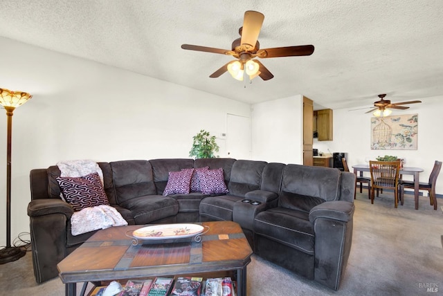 carpeted living room featuring ceiling fan and a textured ceiling