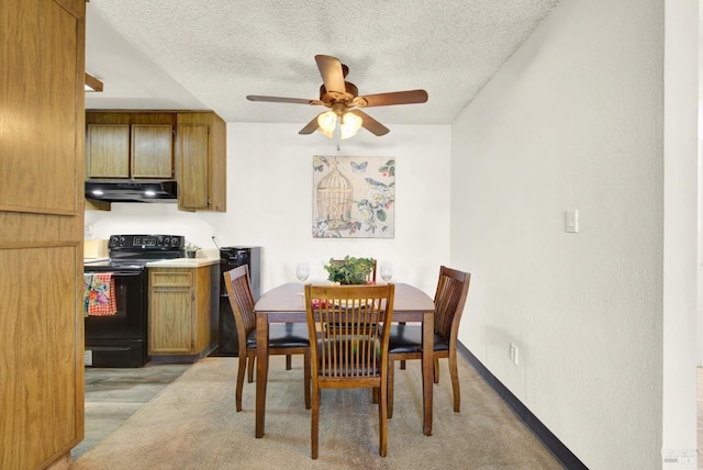 dining area with ceiling fan, light hardwood / wood-style floors, and a textured ceiling