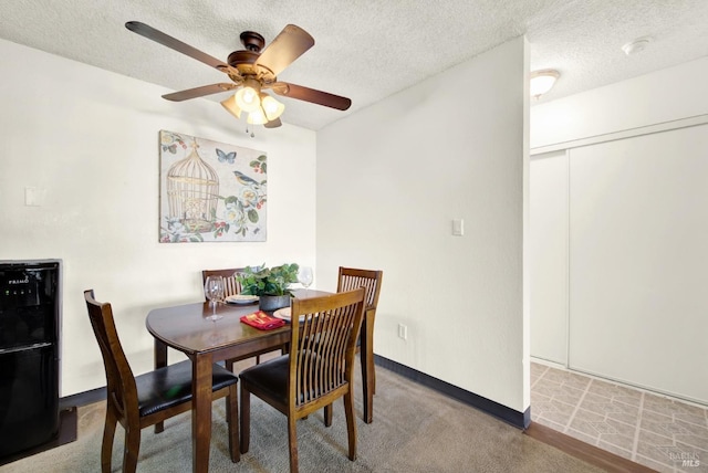 dining room featuring ceiling fan and a textured ceiling